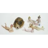 A miniature bisque pincushion doll; and five other dolls, various.