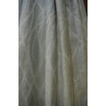 A pair of ivory woven curtains with pale green cut gauze overlay etc.