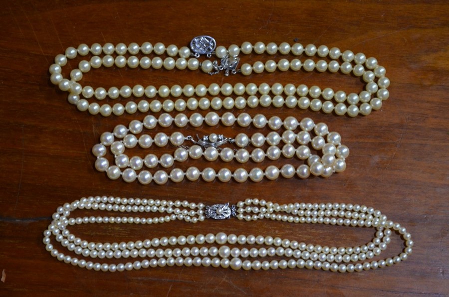 Three rows of various pearls etc.