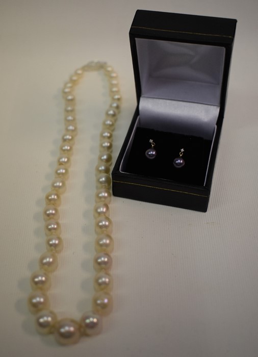 A cultured pearl necklace and pair of pearl and diamond earrings