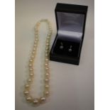 A cultured pearl necklace and pair of pearl and diamond earrings