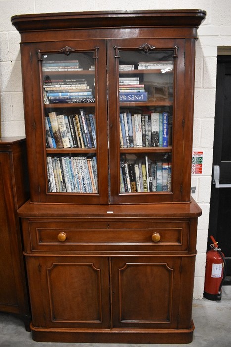 A late Victorian mahogany secretaire bookcase with a pair of glazed doors enclosing three shelves