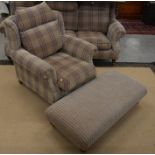 A Parker Knoll country house arm chair and footstool on turned mahogany supports with brass