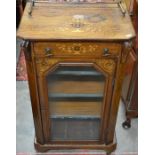 A Victorian inlaid music cabinet with single drawer and glazed door enclosing three shelves