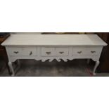 A late 18th/19th century oak low three drawer dresser on cabriole front legs, later painted in chalk