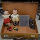 A vintage tan leather suitcase containing three 1940s/50s dolls, a Victorian schoolroom slate and