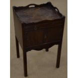 A Georgian style night stand with wavy galleried top, shallow drawer and cupboard doors raised on