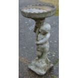 A weathered stone birdbath