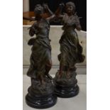 A pair of spelter classical figures on ebonised wooden bases 'Le Dressin' and 'Melodie', after