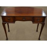 An Edwardian mahogany bow back dressing table with three drawers and pad footed turned supports