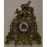 A decorative brass French style twin-train mantel featuring cavalier on horseback
