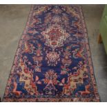A Persian Hamadan blue ground rug with stylised floral design, 212 x 100 cm