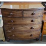 A Victorian mahogany bowfront chest of two short over three long drawers with turned handles and