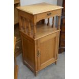 An old pine side cabinet, the raised spindle supported top with shallow drawer over a panelled