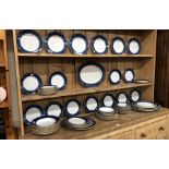 A large quantity of Copeland Spode dinnerware decorated with a wide stippled blue band and gilt rims