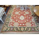 A large Indian Agra carpet, the red ground with large stylised palmettes and leaves linked by