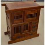 An  Asian hardwood side cabinet with sliding doors and five drawers