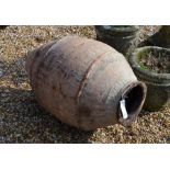 A large weathered terracotta large oil jar