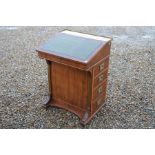 Yew wood davenport with tooled green leather top and four side drawers with brass campaign style