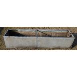 A large galvanized rectangular garden trough