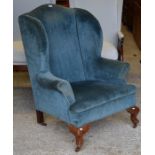 An old wing armchair for re-upholstery