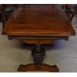 An oak draw leaf refectory style dining table raised on bulbous moulded supports