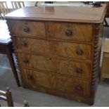 A Victorian mahogany chest of two short over three long drawers with turned handles between spiral