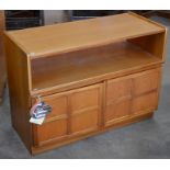 A 'Nathan' mid century teak sideboard with open shelf and a pair of panelled cupboard doors raised