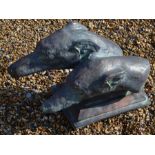 A pair of cast composite bronzed greyhounds mounted on a rectangular base