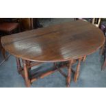 A good quality 18th century style oak drop-leaf dining table with turned gate-leg action supports