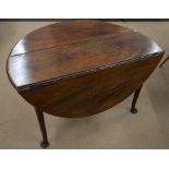 A 19th century mahogany dining table with oval drop leaf top raised on turned gateleg action