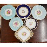 Four Royal Crown Derby plates - three pale blue ground with floral hand-painted centres, two