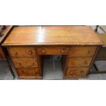 An old stripped pine kneehole desk with seven drawers (A/F)