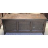 A large panelled dark oak coffer