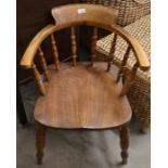 A 19th century elm seated spindle back bow chair, turned supports and stretcher