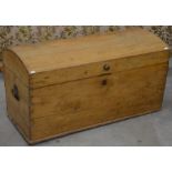 An antique pine dome top seaman's chest with iron handles