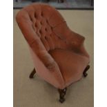A Victorian mahogany framed nursing chair with salmon pink button bask upholstery