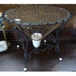 A 1950s circular wire work occasional table with glass top