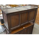 A dark panelled oak blanket chest