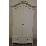A 'Willis & Gambier' French style cream painted wardrobe with two doors enclosing hanging rail