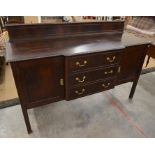 A large mahogany breakfront sideboard with panelled cupboards flanking three central drawers