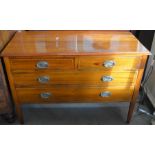 A Edwardian mahogany chest of two short over two long drawers raised on tapering square supports