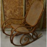 An old Thonet style bentwood and cane panelled rocking armchair