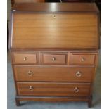A Stag style mahogany bureau with fall front panel enclosing fitted interior over five drawers