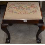 A mahogany framed stool with floral tapestry seat and cabriole supports with ball and claw feet