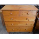 A large waxed pine chest of two short and three long drawers with turned handles and short turned