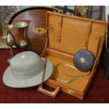 An oval mahogany tray, a pair of Middle Eastern brass candlesticks, a vintage leather tape measure