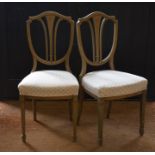 A pair of polychrome painted Sheraton-revival side chairs with shield shaped backs and tapering