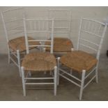 A set of five simulated bamboo cream painted rush seated dining chairs
