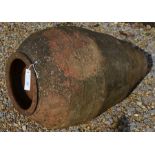 A weathered terracotta olive jar